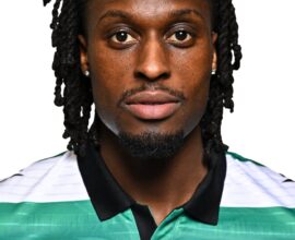 Shamrock Rovers football player in team jersey, close-up portrait.
