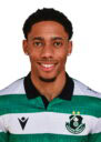 Shamrock Rovers football player in team kit, smiling, Irish club logo visible.
