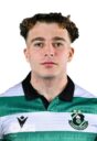 Young male football player in Shamrock Rovers jersey, close-up portrait, team logo visible, focused.