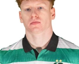 Shamrock Rovers football player in green and white kit with club crest.