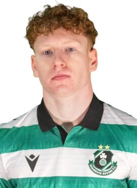 Shamrock Rovers football player in green and white kit with club crest.