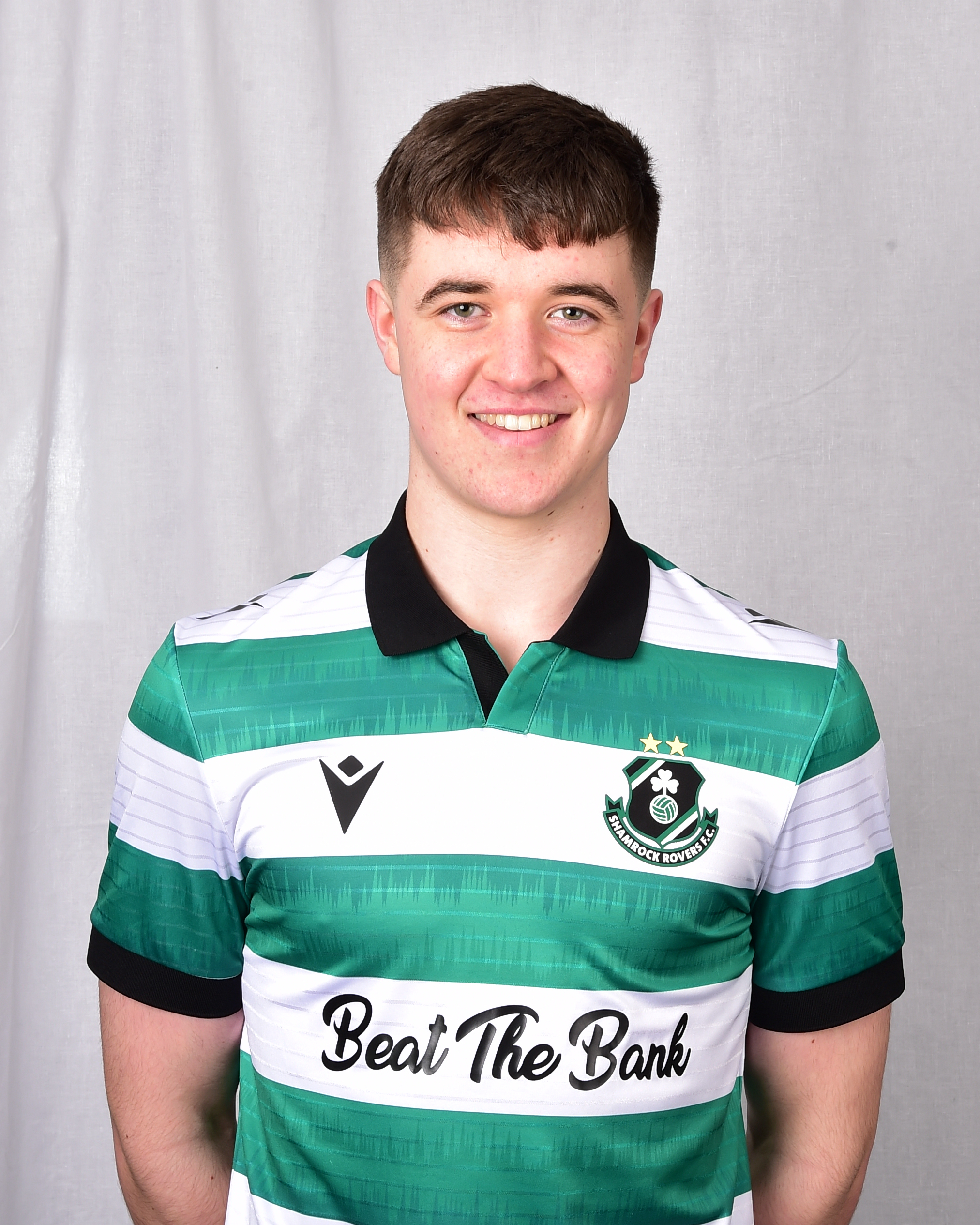 Ronan Dawson wearing Shamrock Rovers football jersey, smiling at camera.