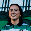 Shamrock Rovers female football player in team jersey at Tallaght Stadium.