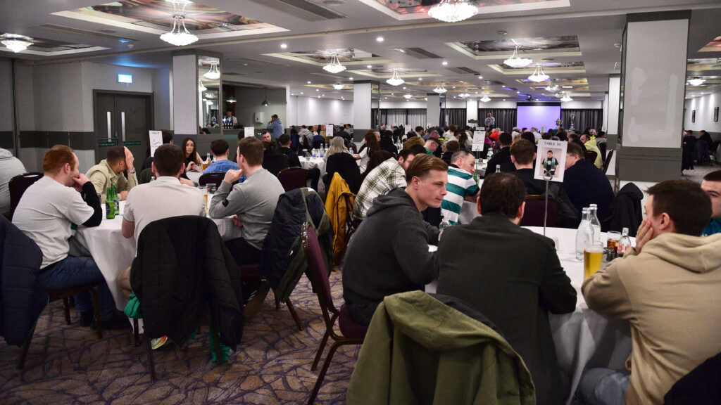 Welcoming crowd at Shamrock Rovers fans event or gathering, enjoying socialising and team atmosphere.