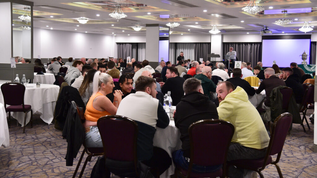 Enjoying a team event at a Shamrock Rovers club awards dinner in a conference hall.