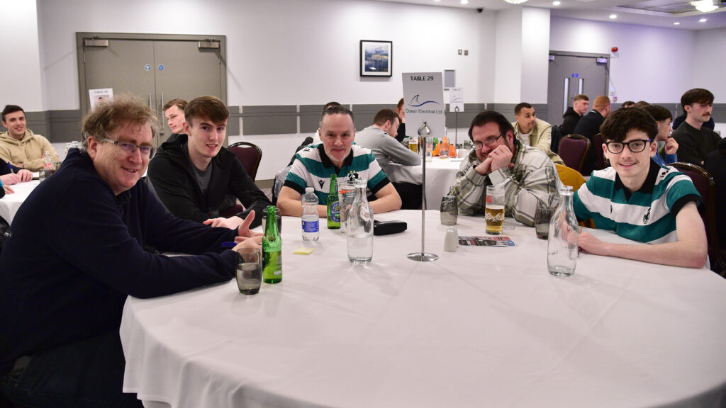 Enjoying team spirit at Shamrock Rovers match, players and fans celebrate together at the Irish football club.