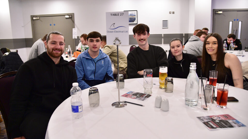 Happy Shamrock Rovers fans enjoying team event at the football club's gathering.