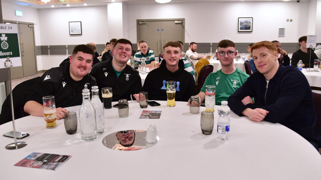 Shamrock Rovers players at an event, enjoying drinks and camaraderie.