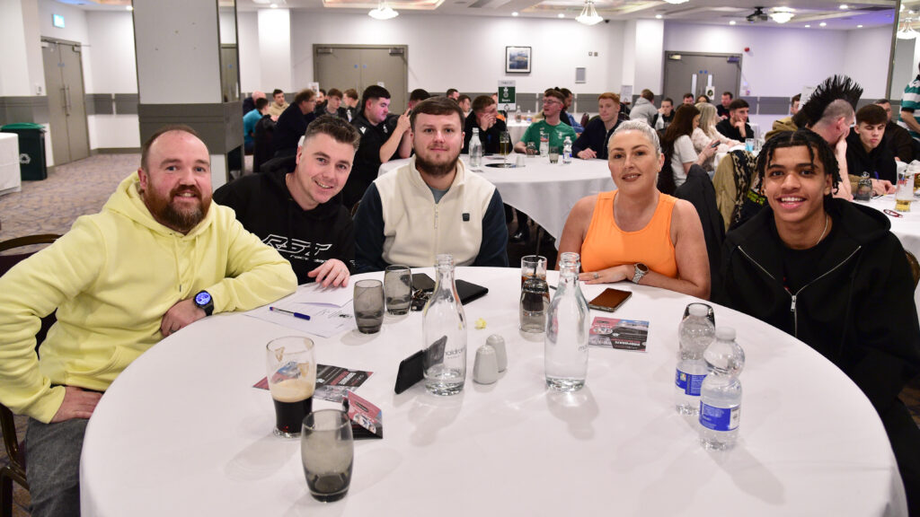 Cheerful fans at Shamrock Rovers supporter event enjoying team spirit and socialising.