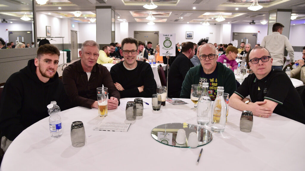 1. Shamrock Rovers fans enjoying a social event in a banquet hall.