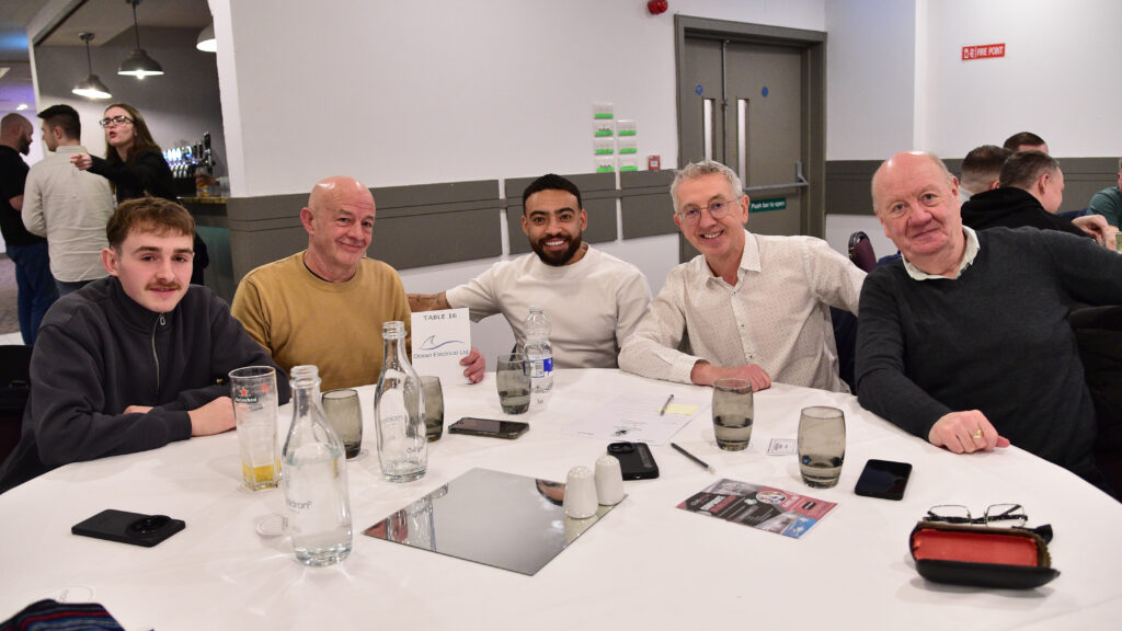 Happy football fans enjoying a matchday event at Shamrock Rovers stadium, showcasing team spirit and fan engagement in Irish football.