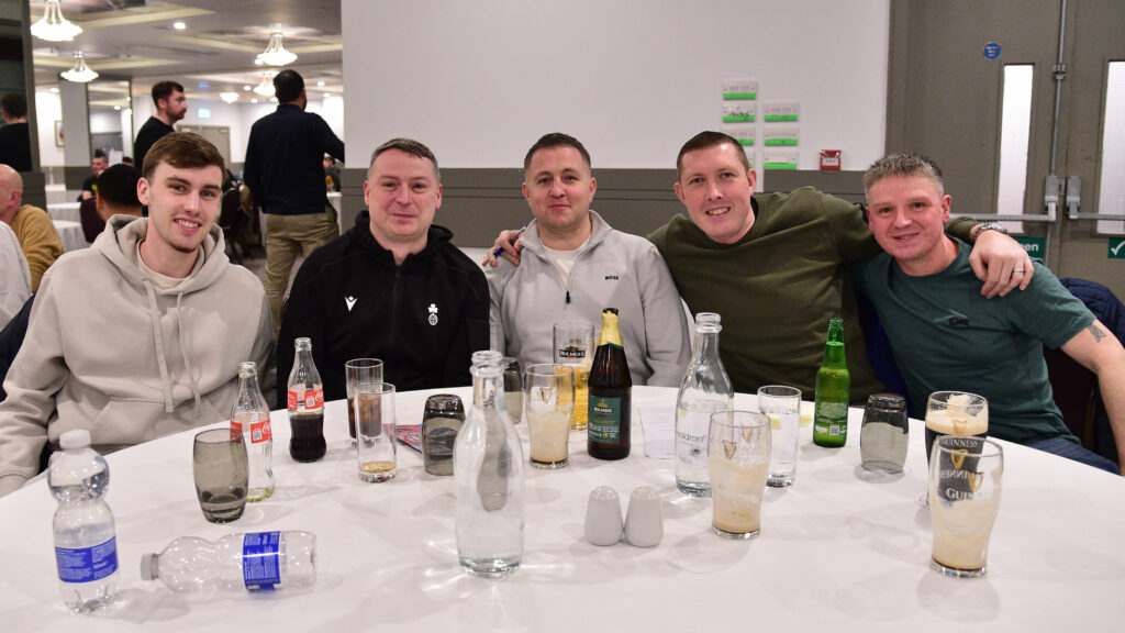 Happy Shamrock Rovers fans enjoying a match celebration at the stadium.