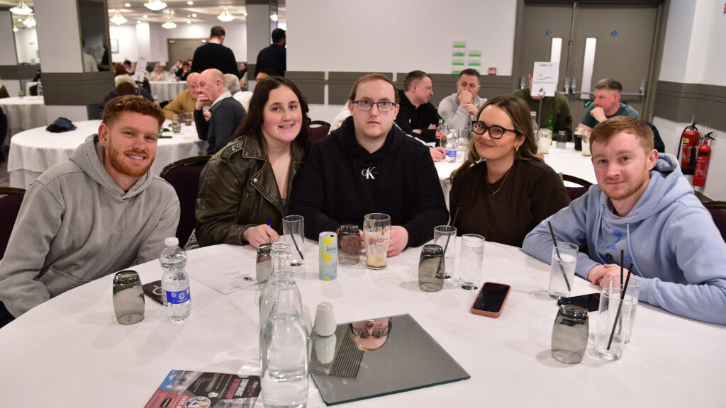 Fans enjoying an event with Shamrock Rovers football team, celebrating in a social setting.