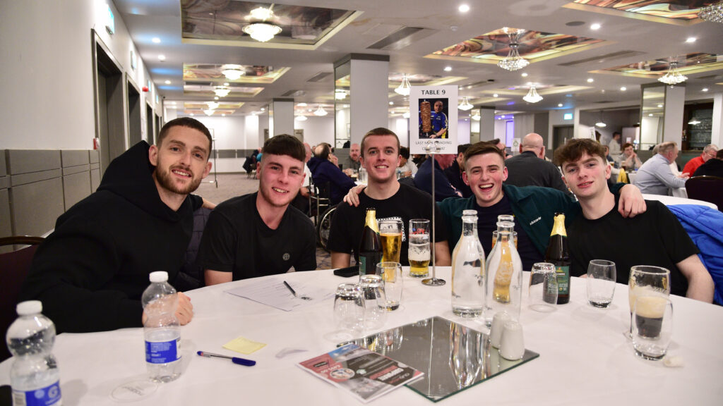 Happy Shamrock Rovers fans enjoying a team celebration at a banquet in Dublin.