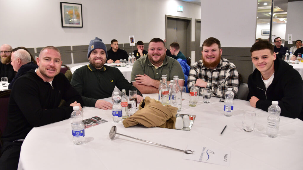 Cheerful Shamrock Rovers fans dining at a team event, showcasing team spirit and community support.