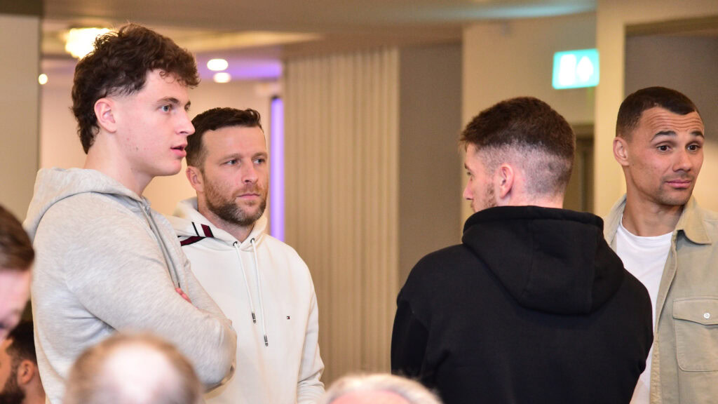 Young football players during team meeting at Shamrock Rovers training session or event.