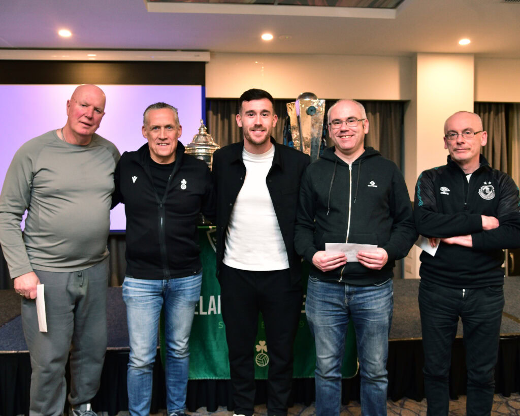 Legendary Shamrock Rovers football team members celebrating victory at an event in Ireland.