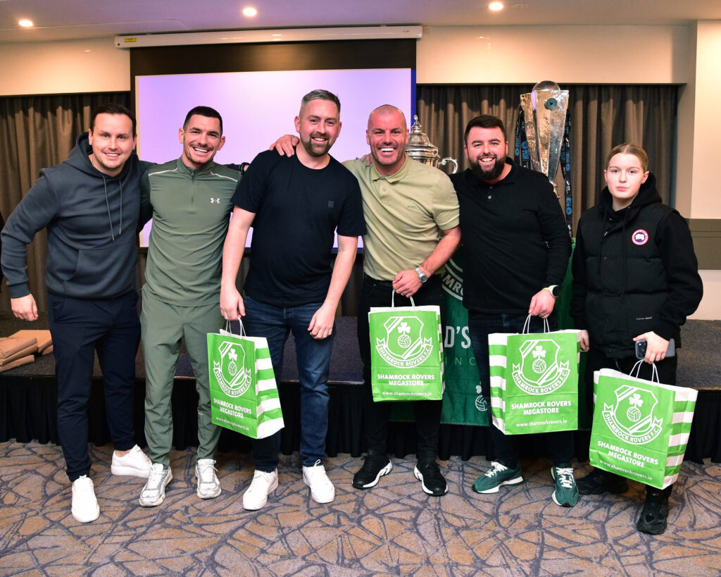 Celebrating Shamrock Rovers success with players and fans at a club event, showcasing team spirit and community support.
