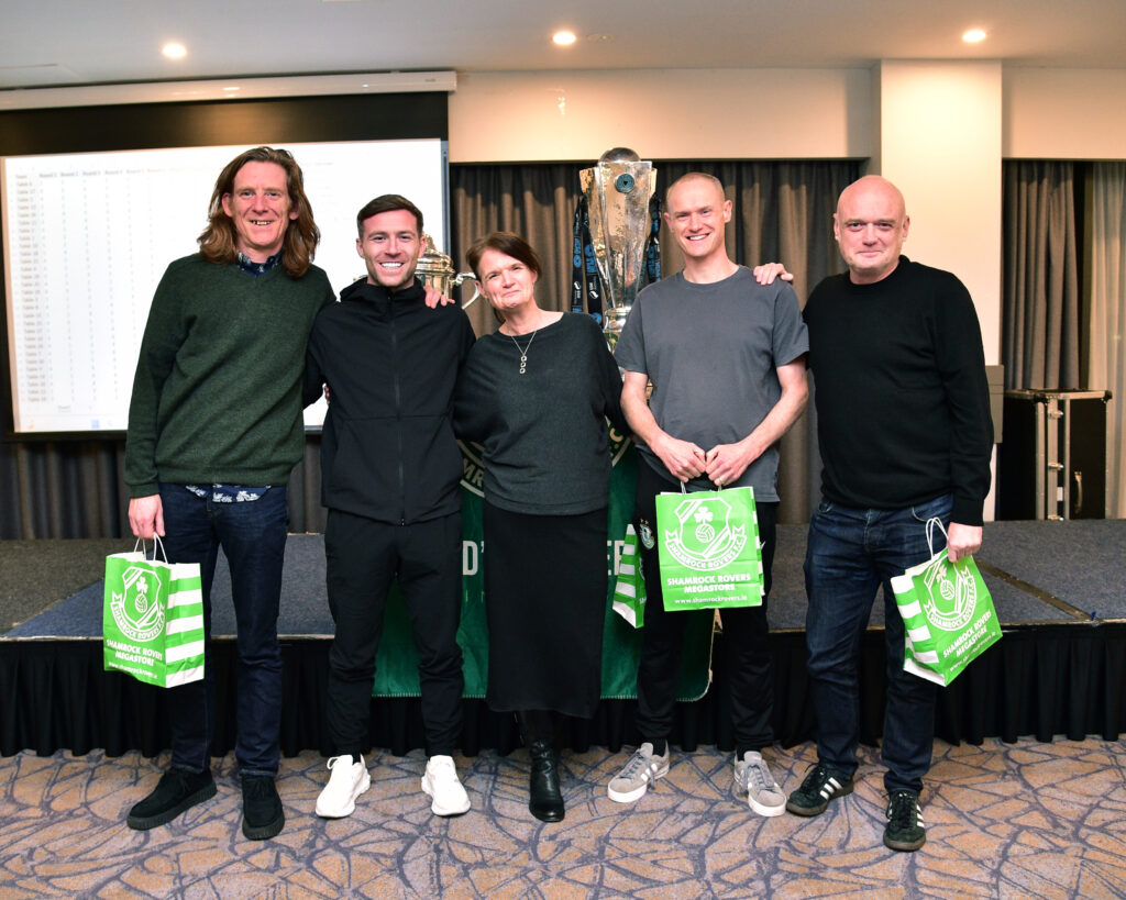 Irish football team celebrating victory at Shamrock Rovers event.
