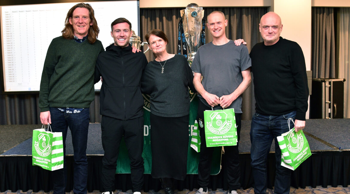 Irish football team celebrating victory at Shamrock Rovers event.