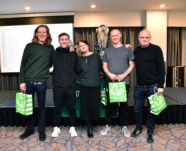 Irish football team celebrating victory at Shamrock Rovers event.