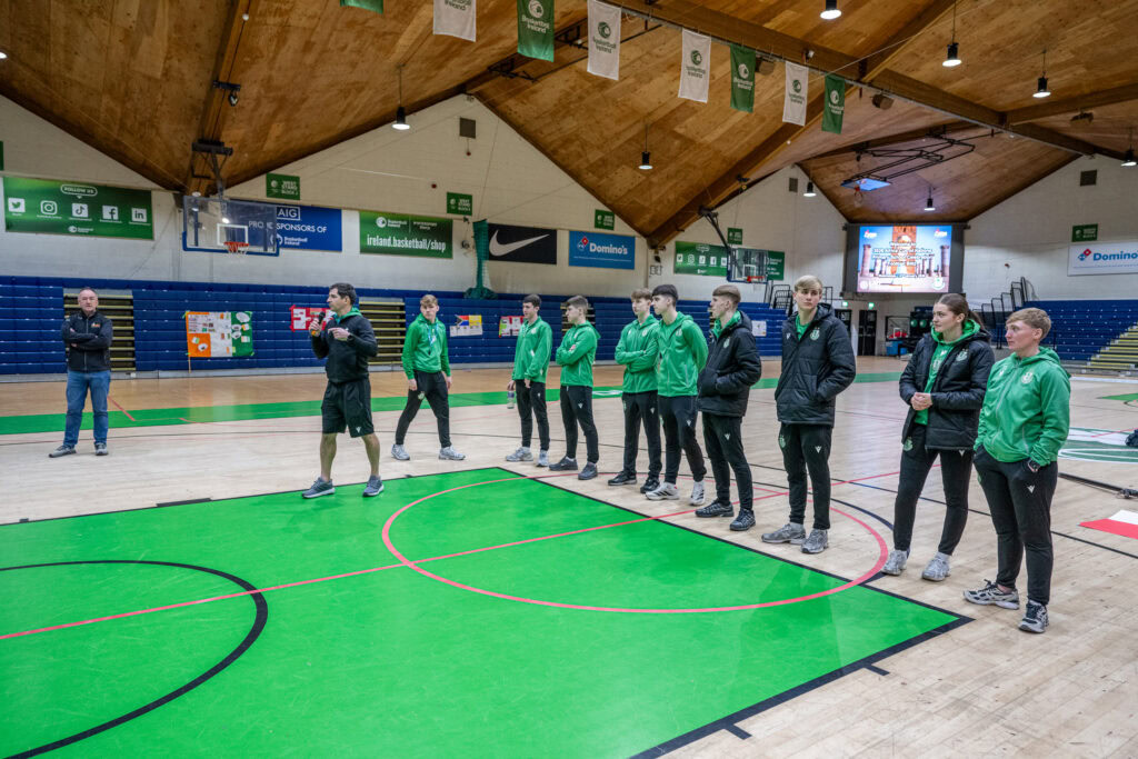 Pre-match team briefing at indoor basketball court, Shamrock Rovers youth academy training session.