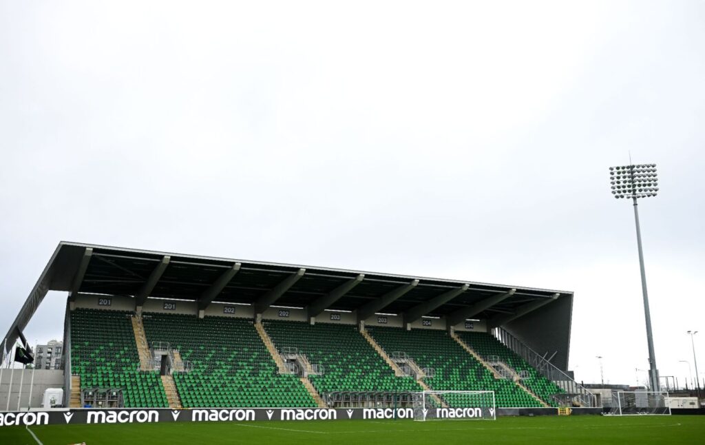 Shamrock Rovers stadium with green seats and floodlights, home of Irish football club.