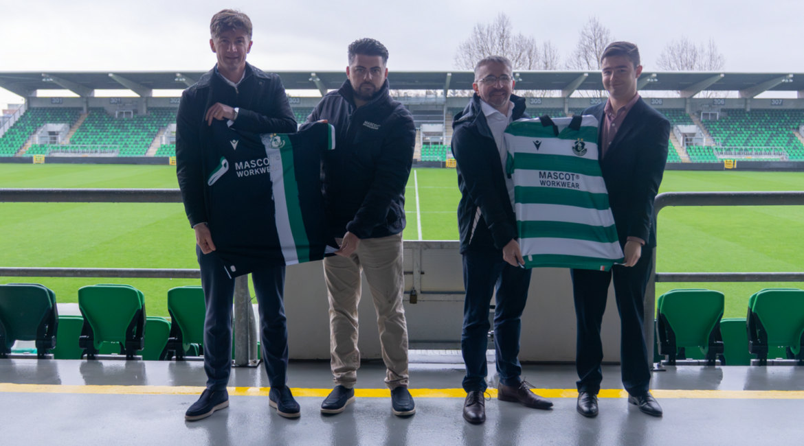 Shamrock Rovers team members holding club jerseys at Tallaght Stadium.