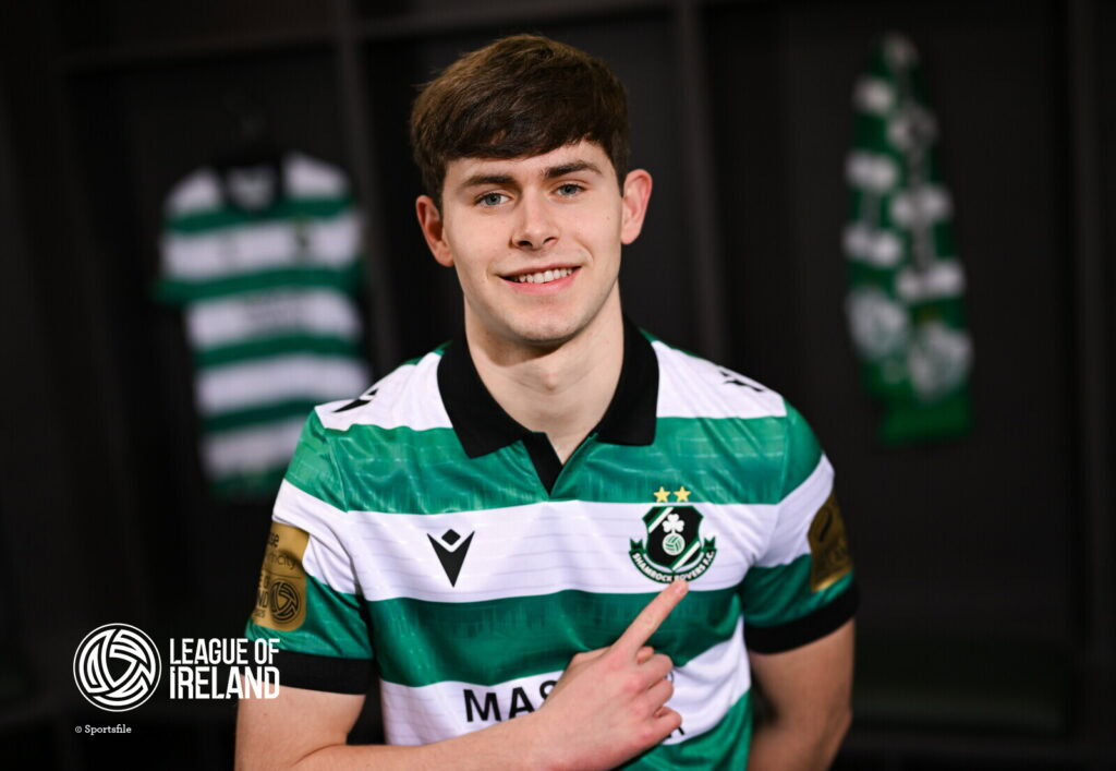 Young Shamrock Rovers player smiling in team jersey, League of Ireland.