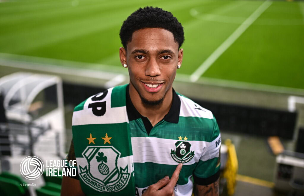 Shamrock Rovers player in green and white striped jersey at Tallaght Stadium.