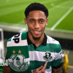 Shamrock Rovers player in green and white striped jersey at Tallaght Stadium.