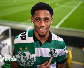 Shamrock Rovers player in green and white striped jersey at Tallaght Stadium.