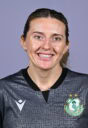 Shamrock Rovers female player smiling in team jersey, close-up portrait.