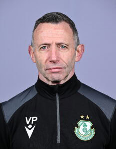 Shamrock Rovers coach in team jacket with club crest, facing camera against plain background.