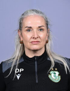 Female Shamrock Rovers player in team jersey, close-up portrait.