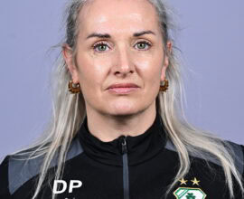 Female Shamrock Rovers player in team jersey, close-up portrait.