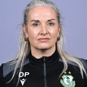 Female Shamrock Rovers player in team jersey, close-up portrait.