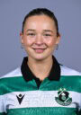 Female football player in Shamrock Rovers jersey smiling.