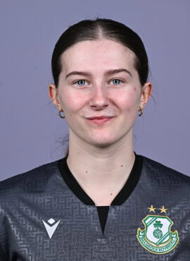 Shamrock Rovers female football player in team jersey with club crest.