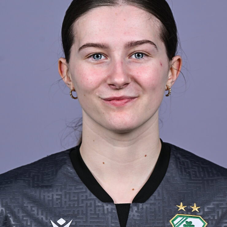 Shamrock Rovers female football player in team jersey with club crest.