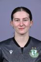 Shamrock Rovers female football player in team jersey with club crest.