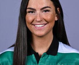 Female football player in Shamrock Rovers jersey smiling.