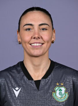 Female Shamrock Rovers player smiling in team jersey.