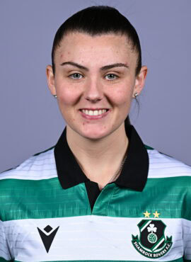 Female Shamrock Rovers player smiling in team jersey.
