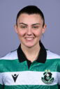 Female Shamrock Rovers player smiling in team jersey.