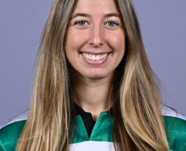 Shamrock Rovers female football player smiling in team jersey.