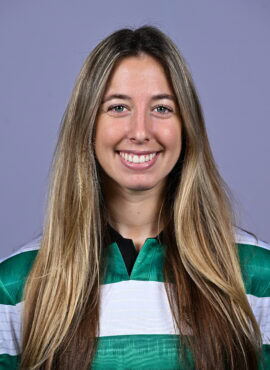 Shamrock Rovers female football player smiling in team jersey.