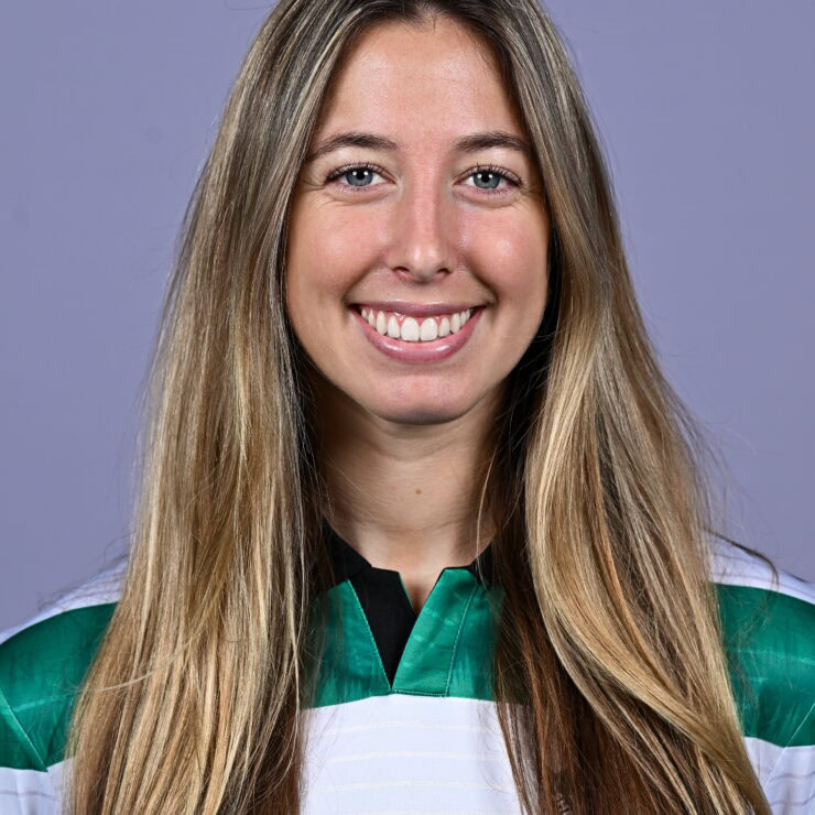 Shamrock Rovers female football player smiling in team jersey.