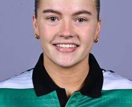 Shamrock Rovers female football player smiling in team jersey.