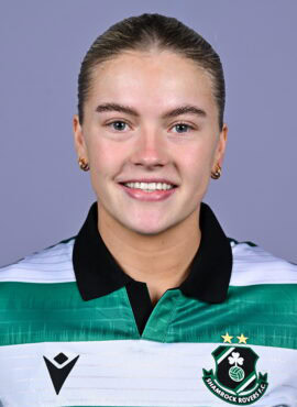 Shamrock Rovers female football player smiling in team jersey.